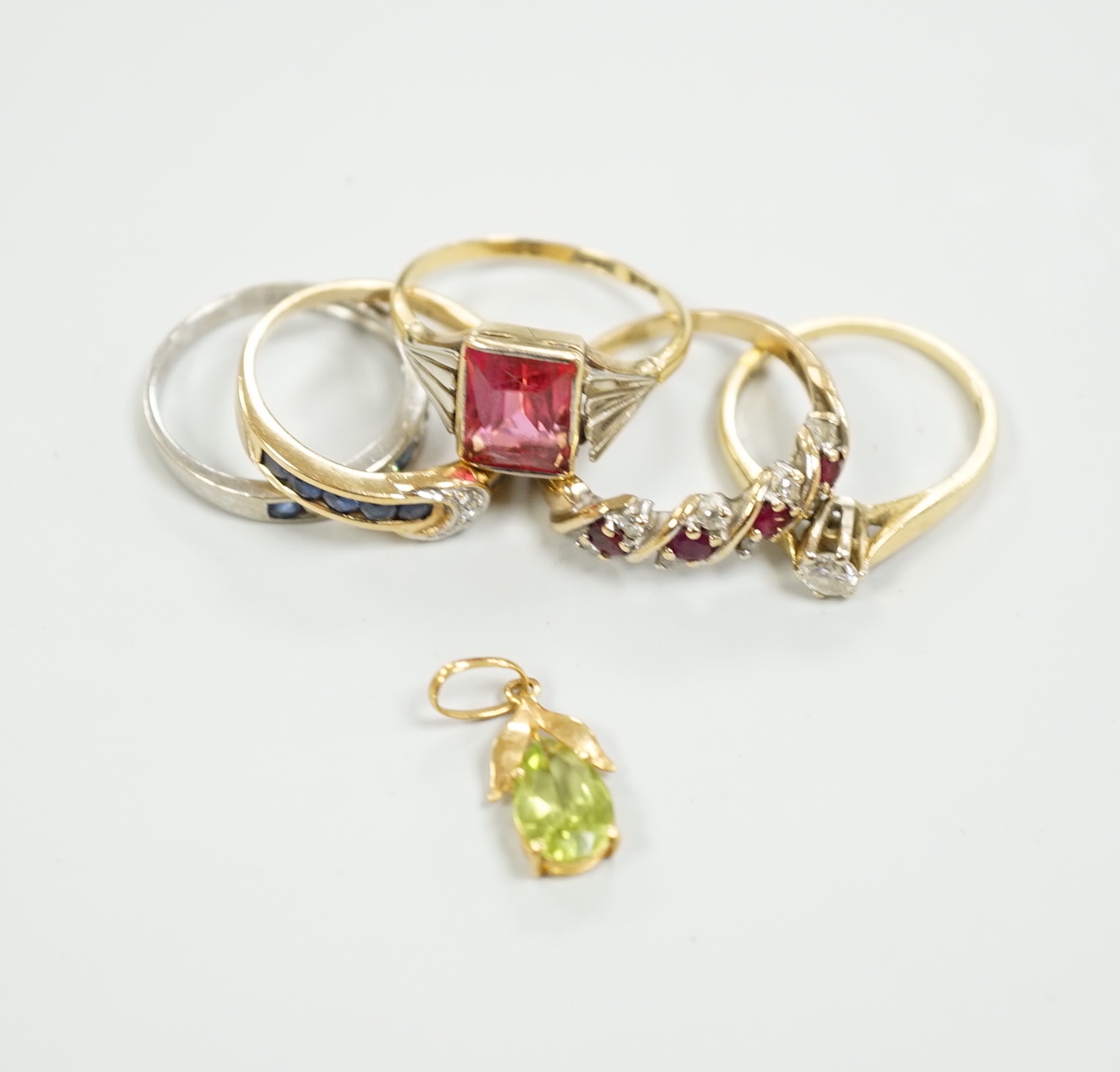 Three assorted 9ct gold and gem set rings, gross 6.7 grams, two 18ct and gem set rings including solitaire diamond and a 750 and gem set small pendant, gross 6.1 grams.
